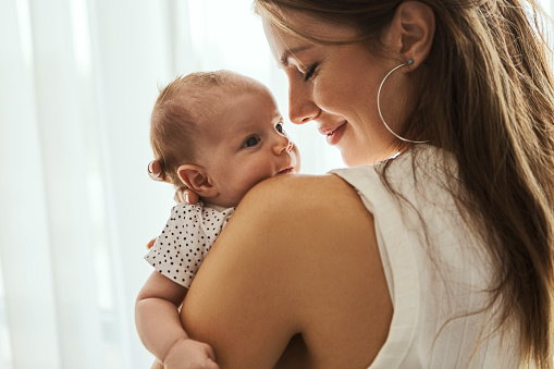 mom hugging baby